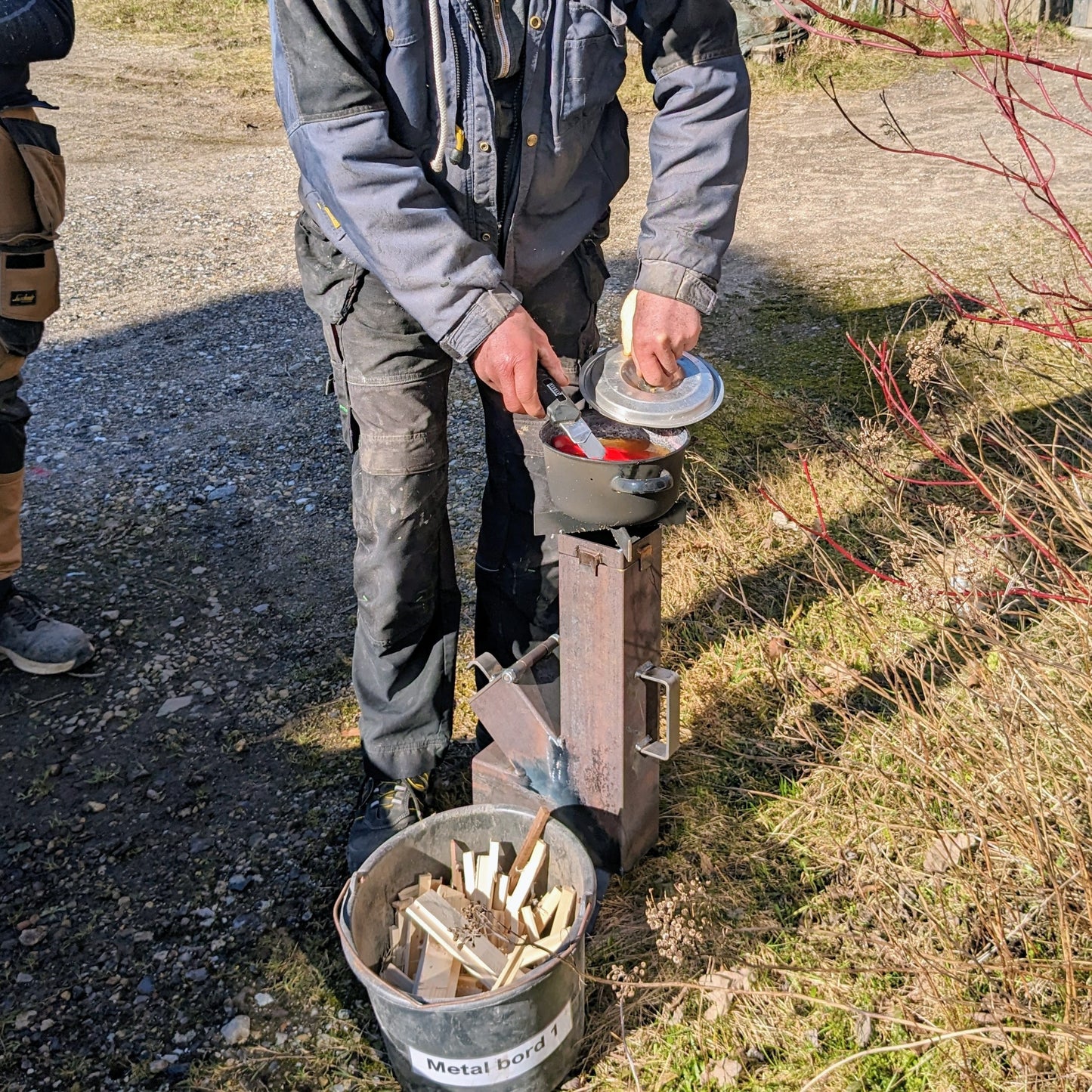 Her ses rocket stovet i brug til at koge pølser.
