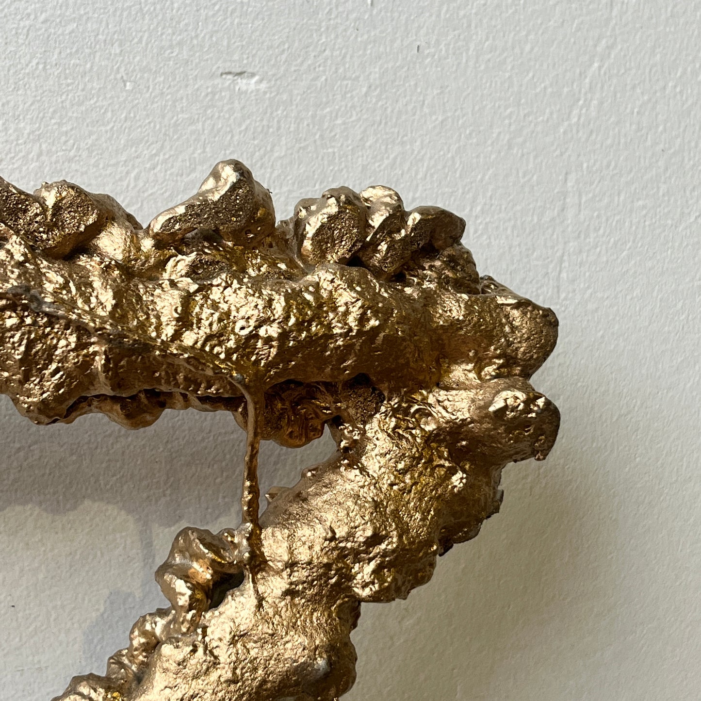 Nærbillede af julestjerne til ophæng ind eller ude. Produceret i genbrugt armeringsstål beklædt med guldmalet skum hos Råt&Godt -fordi mennesker og materialer fortjener en chance til.